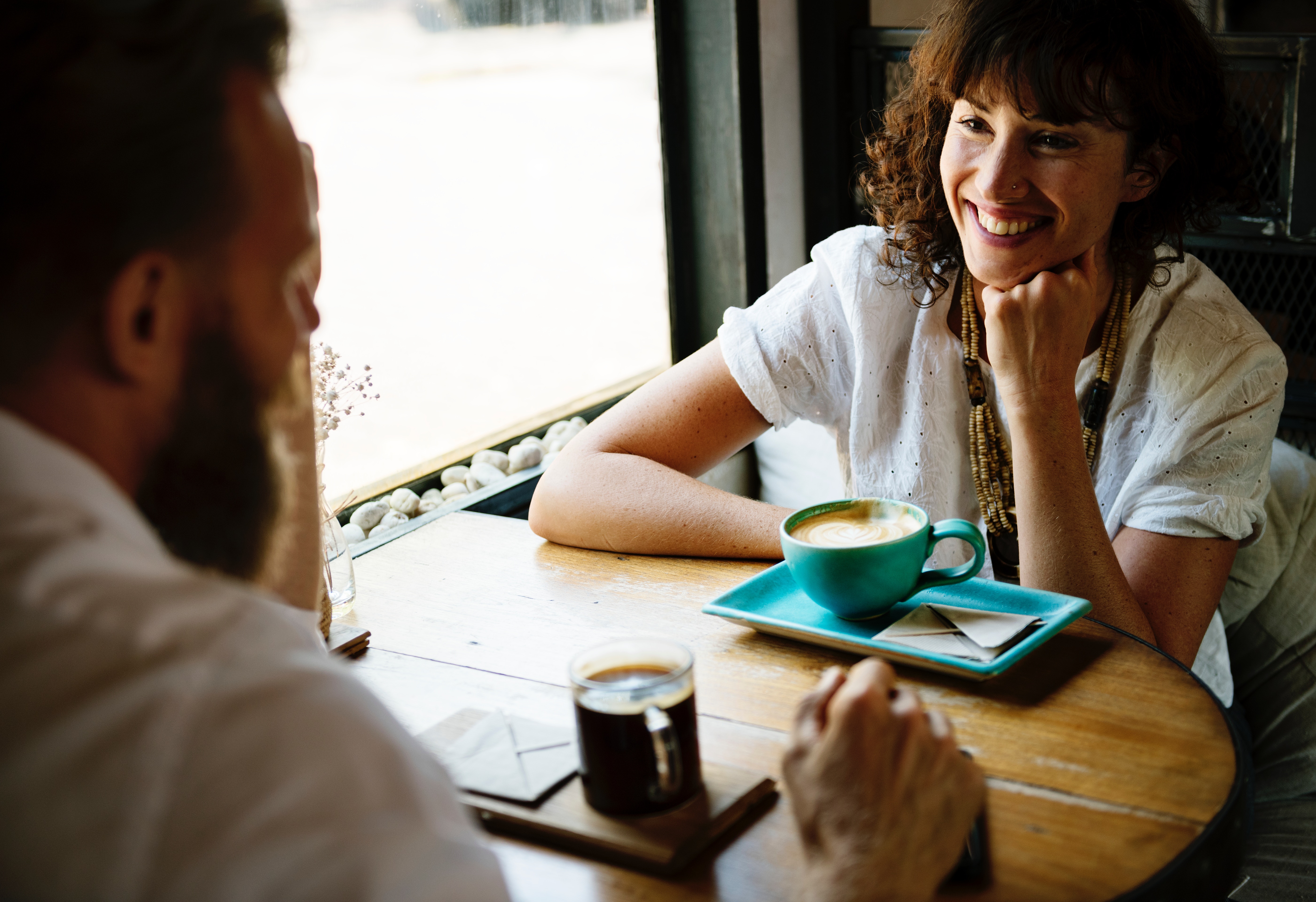 two people talking over a cup of coffee