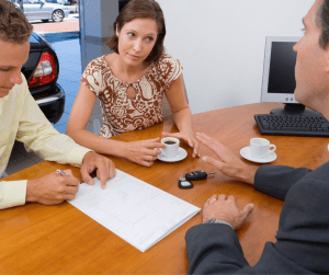 A landlord takes his tenants through the details of paying rent before they sign their lease.